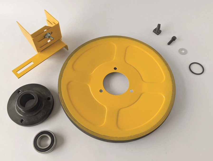 A collection of Startrite Spares, including a band wheel, a band wheel hub, a bearing, a lower guard, a screw, washer, guides & an ring